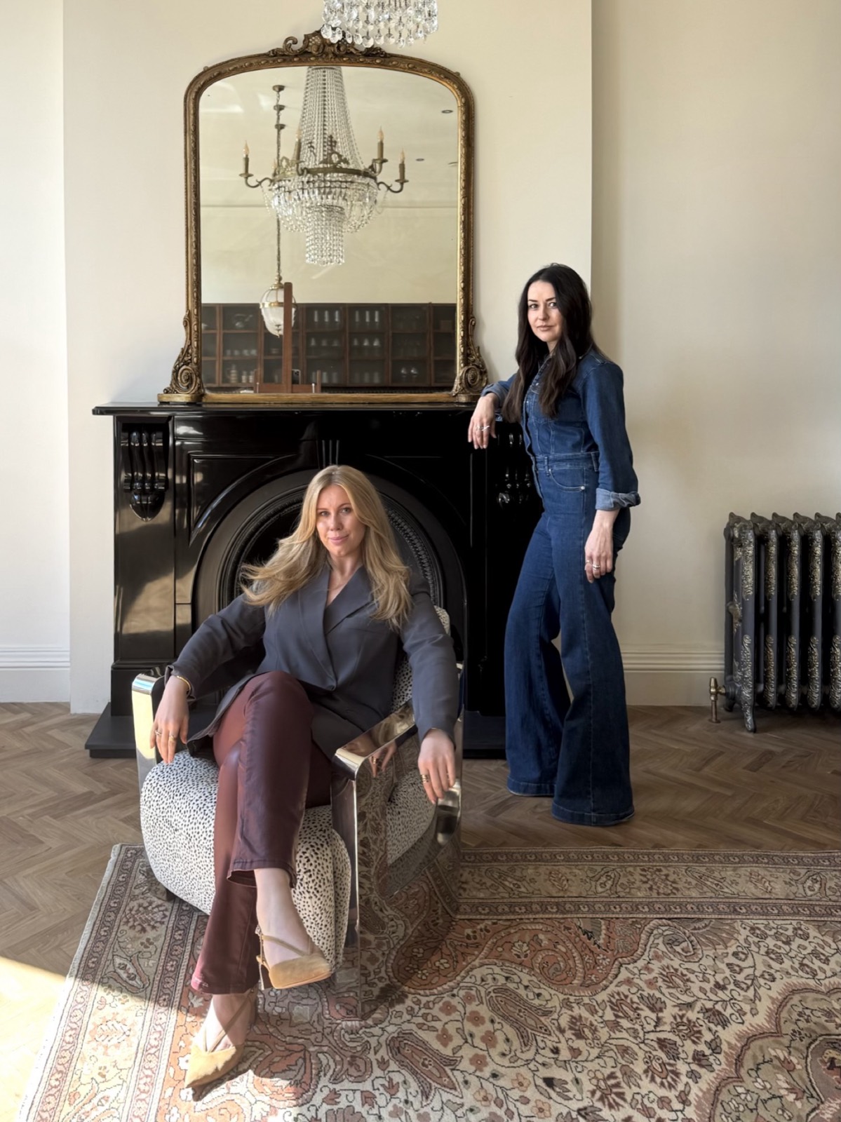 Jelena and Sarah with antique furniture in a restored room