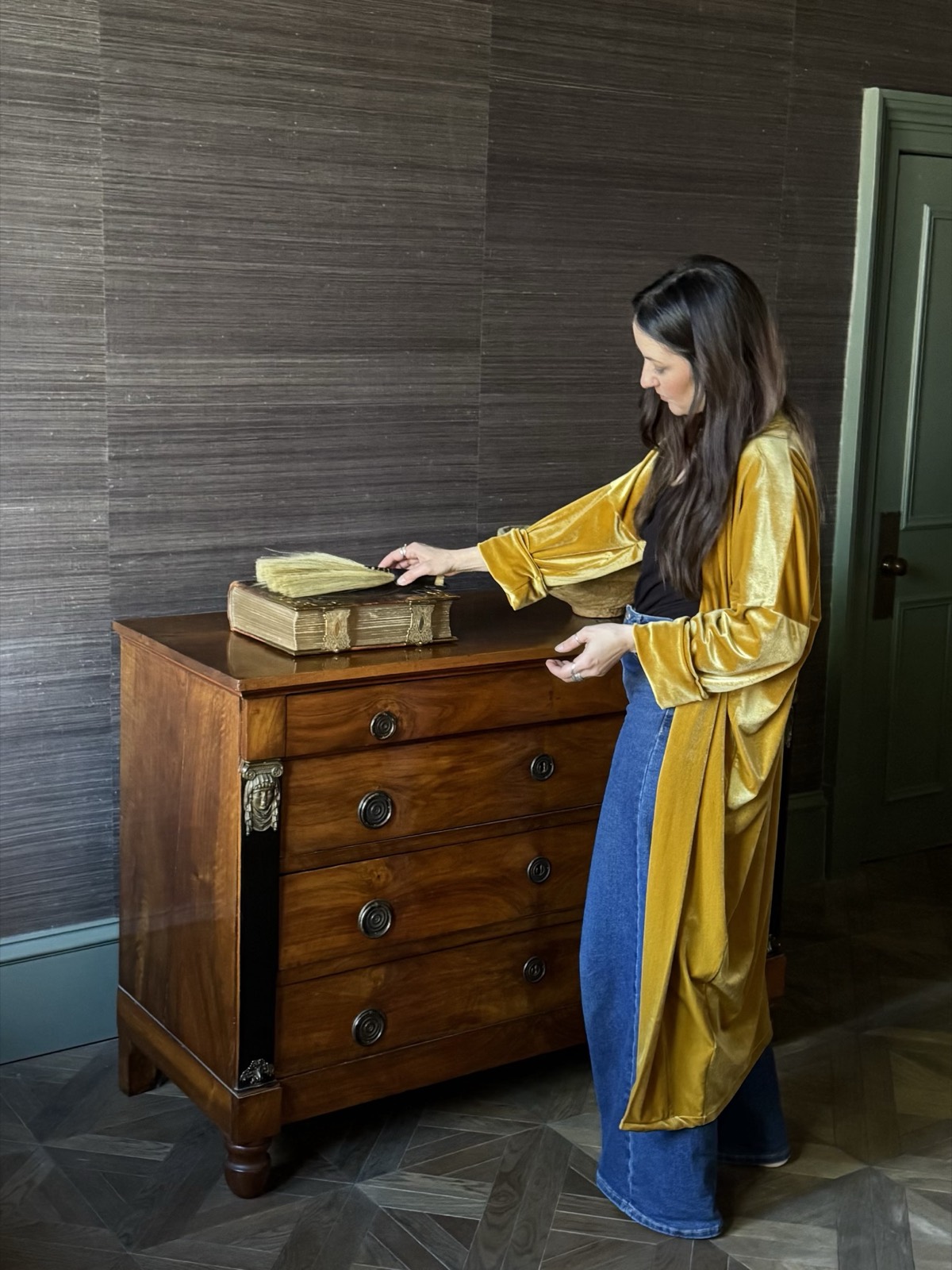 Inspecting an antique chest and decorative object